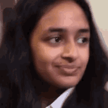a close up of a woman 's face with a slight smile on her face .