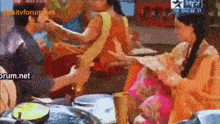 a group of people are gathered around a table with a star tv logo on the bottom right