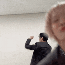 a blurry picture of a man and a woman dancing in a room .