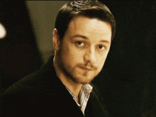 a man with a beard wearing a black jacket