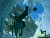 a person is doing a handstand in an ice cave on make a gif