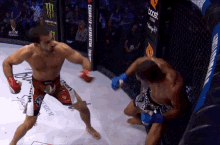 a man in a boxing ring with a monster energy ad behind him