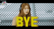 a girl wearing headphones is saying bye