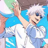 a man wearing sunglasses is holding a beach ball in his hand