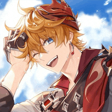 a boy with a red crown on his head is smiling for the camera