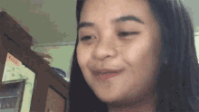 a close up of a woman 's face making a funny face in a kitchen .
