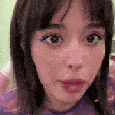 a close up of a girl 's face with the letters xg on the bottom right