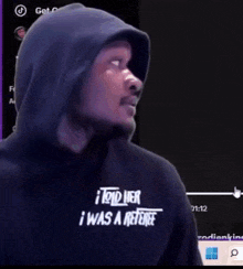 a man wearing a hooded sweatshirt that says i told her i was a referee