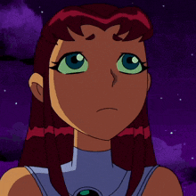 a close up of starfire 's face with green eyes
