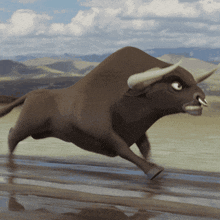 a bull with horns is running in the desert