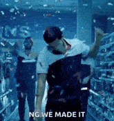 a man dancing in a store with the words ng we made it