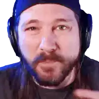 a man with a beard wears headphones and a blue hat