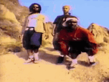a group of people standing on a dirt road