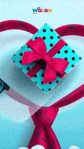a blue gift box with a red bow is surrounded by a red tie