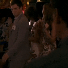 a man in a suit has a name tag on his jacket