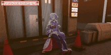 a woman in a purple dress is laying on the ground in front of a building that says business