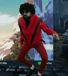 a man in a red jacket and red pants is dancing in front of a mountain