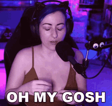 a woman wearing headphones talking into a microphone with the words oh my gosh written below her