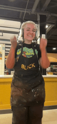a woman wearing an apron that says blick