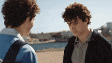 a couple of men standing next to each other with a blurred background that says ' anyone ' on it