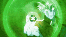a person is holding a green recycle symbol in their hand