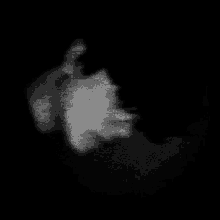 a black and white photo of a person 's face in the dark