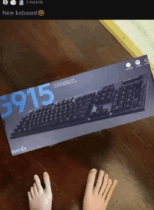 a person 's feet are next to a keyboard box that says 6915