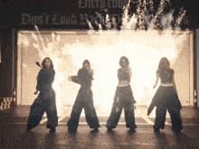 four women are dancing in front of a sign that says don 't look back