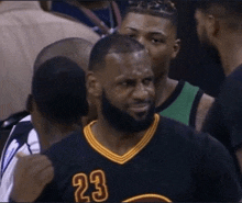a basketball player with the number 23 on his shirt