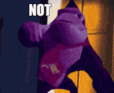 a purple stuffed animal with a red shirt that says ok on it