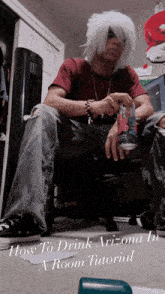 a man in a wig is sitting in a chair holding a can of soda