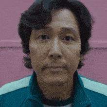 a close up of a man 's face against a pink background