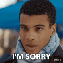 a man wearing a scarf and a jacket says i 'm sorry