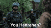 a police officer talking to a woman with the words you hanrahan below him