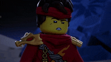 a lego character with his eyes closed and a red scarf around his head