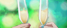a woman with blue nail polish is holding two champagne glasses