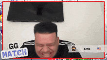 a man is making a funny face in front of a gg match screen