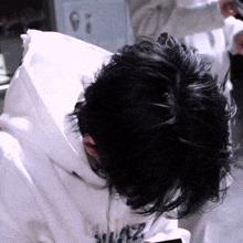 a close up of a person 's head with a white hoodie that says supreme