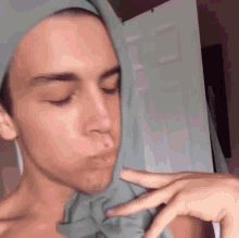 a close up of a person 's face with their hand on their nose