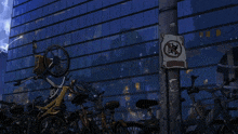 a bunch of bicycles are parked in front of a building with a no parking sign