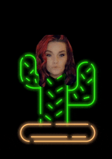 a neon sign of a cactus with a woman 's face behind it