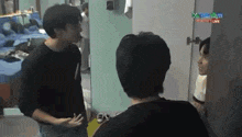 a group of men are standing next to each other in a room .