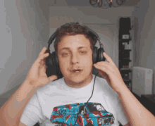 a man wearing headphones and a t-shirt with a blue van on it
