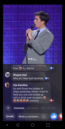 a man in a suit and tie stands in front of a microphone with the words well on the screen