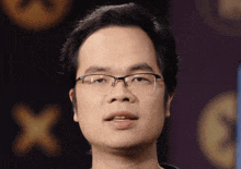a close up of a man wearing glasses with a purple background