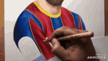 a person is drawing a picture of a man in a red blue and yellow shirt