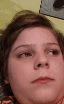 a close up of a person 's face with a serious look on his face