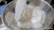 a metal bowl filled with flour and butter with the words made in animatica on the bottom