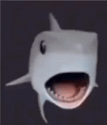 a close up of a shark with its mouth open and its teeth visible .