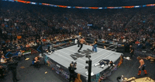 a wrestler is laying on the ground while a referee watches